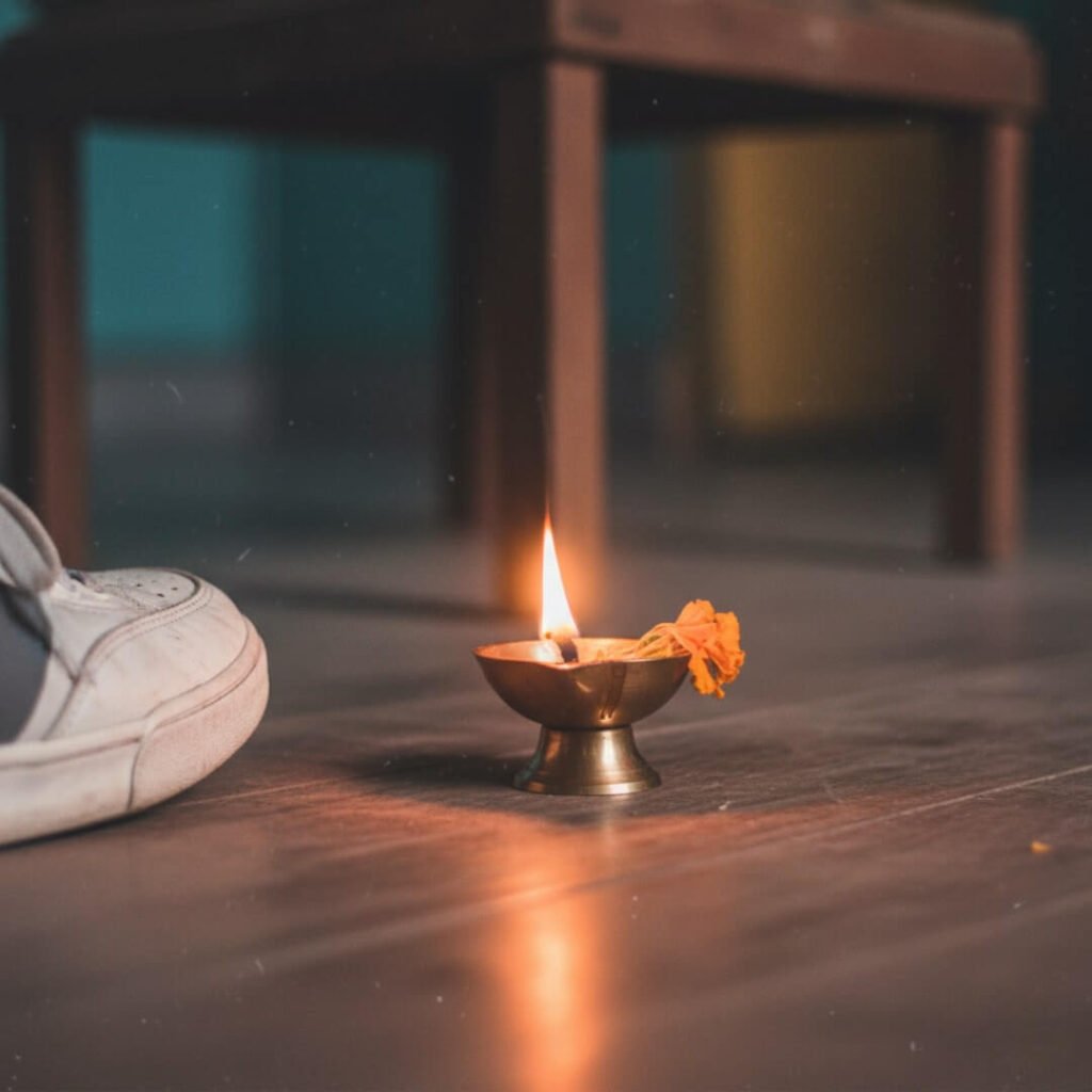 Close-up of diya, sad petal, and sneaker.