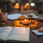 My Messy Life with Daily Meditation Mantras Mumbai table: diya, notebook, marigolds.